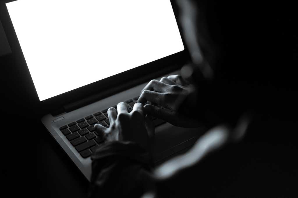 Hacker working on a laptop